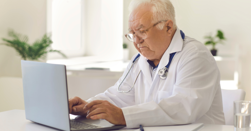 electronic health record sample on screen in front of doctor