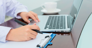 electronic medical records cerner with female doc with laptop in front of her