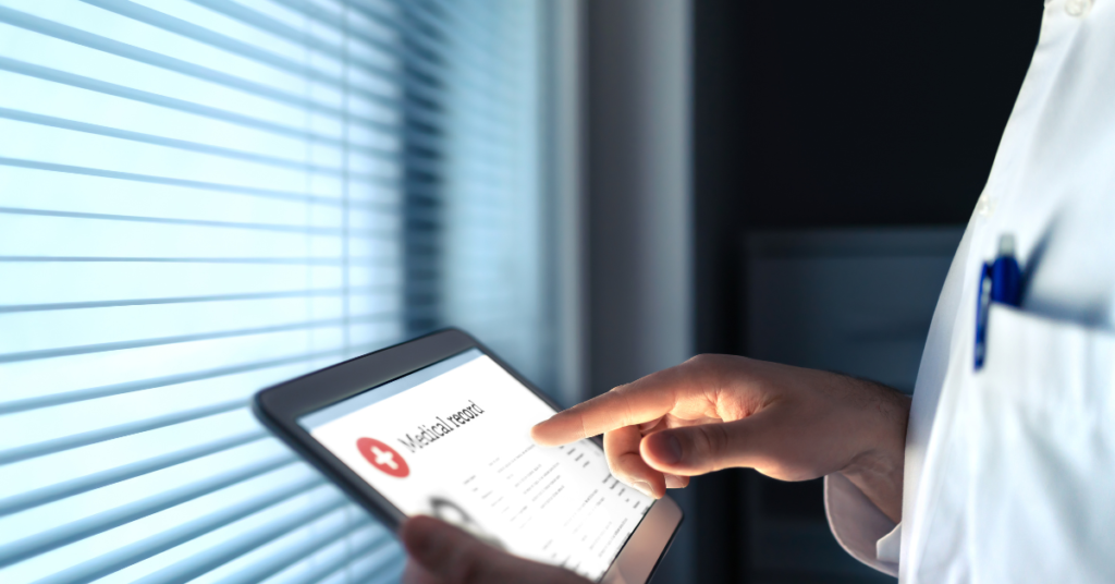 examples of electronic medical record shown by doc holding a tablet with medical record on it