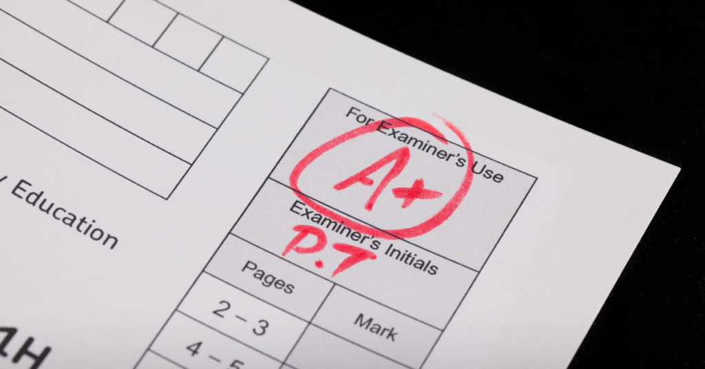 physician licensure exam result shown by an A+ on an exam paper